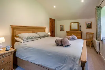 a bedroom with a large bed with two pillows on it at 7 Bed in Talgarth oc-h30349 in Talgarth