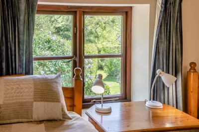 a bedroom with a bed and a large window at 7 Bed in Talgarth oc-h30349 in Talgarth