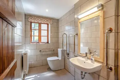a bathroom with a sink and a toilet and a mirror at 7 Bed in Talgarth oc-h30349 in Talgarth