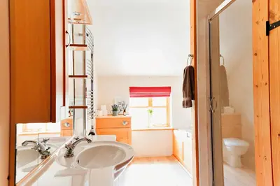 a bathroom with a sink and a tub at Finest Retreats - The Welsh Farmhouse in Aberystwyth