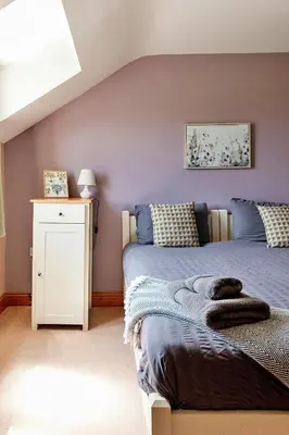 a bedroom with a bed and a white night stand at Finest Retreats - The Welsh Farmhouse in Aberystwyth