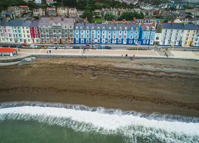 an aerial view of a beach with blue buildings at 2 Bed in Capel Bangor oc-m30146 in Capel Bangor