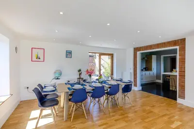 a dining room with a table and blue chairs at 5 Bed in Pant-y-Dwr oc-w30200 in Pant-y-dwr