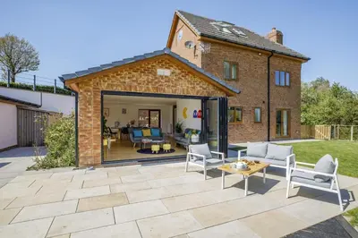 an extension to a brick house with a patio at 5 Bed in Pant-y-Dwr oc-w30200 in Pant-y-dwr