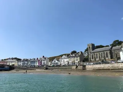a view of a beach with houses and the water at Seafront House in Aberdyfi