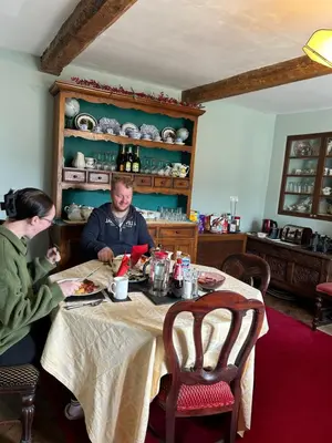 a man and a woman sitting at a table at Enchmarsh Farm Byre in Church Stretton