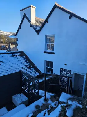 a white house with snow on the roof at Bryn Aber-The House on the Hill in Llangollen