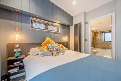 a bedroom with a large bed and a bathroom at Coogee View Lodge in New Quay
