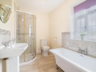 a bathroom with a tub and a sink and a toilet at Court House in Hay-on-Wye