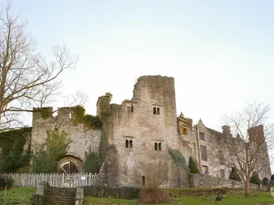 an old castle with a fence in front of it at Court House in Hay-on-Wye