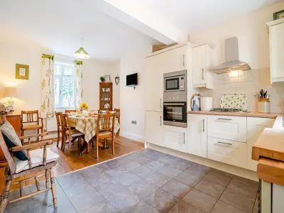 a kitchen and dining room with a table and chairs at Court House in Hay-on-Wye