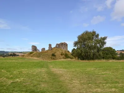 an old castle on a hill in a field at The Bothy-E2934 in Clun