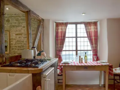 a kitchen with a stove top oven next to a window at The Bothy-E2934 in Clun