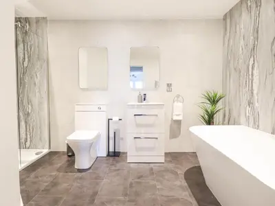 a bathroom with a sink and a toilet and a tub at Aelfor in Harlech