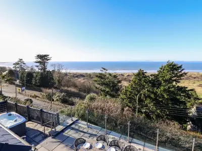 a view of the beach from the balcony of a house at Aelfor in Harlech