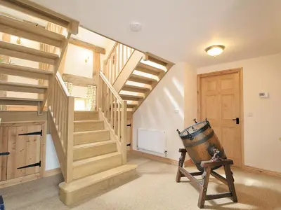 a room with wooden stairs and a wooden door at The Olde Granary - E4298 in Halston