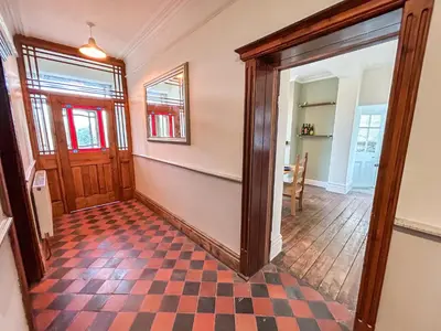 a hallway with a checkered floor in a house at Glannant - 5 Bed & 4 Bathroom - Fairbourne, Barmouth, Mawddach Estuary in Arthog