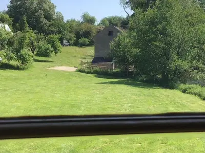 an image of an old barn in a field at Ashford Bridge Barn in Ludlow
