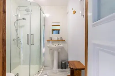 a bathroom with a glass shower and a sink at Ashford Bridge Barn in Ludlow