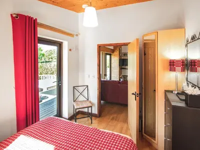 a bedroom with a red bed and a bathroom at Ash Lodge - Hw7442 in Nantmel