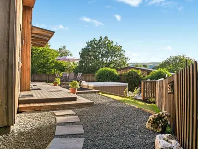 a garden with a wooden fence and a patio at Ash Lodge - Hw7442 in Nantmel