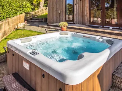 a jacuzzi tub on the deck of a house at Ash Lodge - Hw7442 in Nantmel