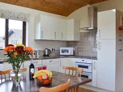 a kitchen with a table with a bunch of bananas on it at Ithon Bank - Hw7478 in Penybont