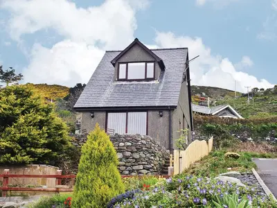 a small house with a gambrel roof at Morlais - Hw7599 in Llanaber
