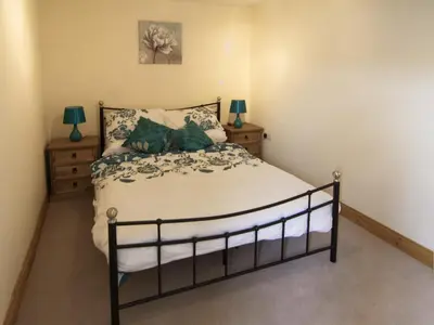 a bedroom with a bed and two night stands at Cefnaire Isaf in Newtown