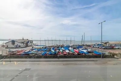 a bunch of boats are lined up in a parking lot at Popular Sea View Apartment in Aberdyfi