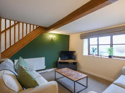 a living room with a couch and a tv at Uk46590 - Longmynd in Church Stretton