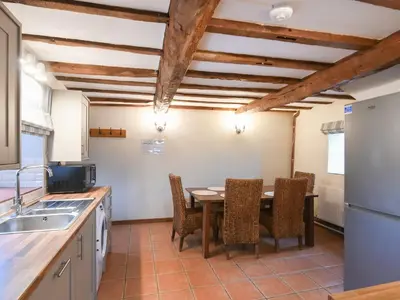 a kitchen with a dining room table and chairs at Uk46590 - Longmynd in Church Stretton