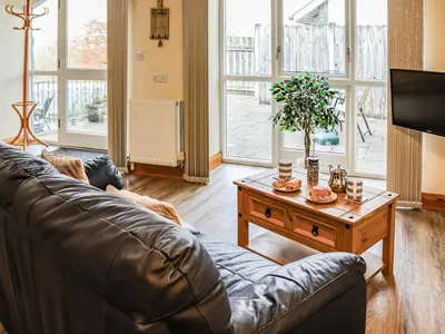 a living room with a leather couch and a coffee table at Hirnant - Uk48512 in Bala