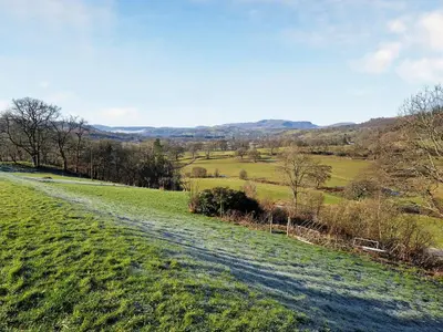 a dirt road in a field with green grass at Hirnant - Uk48512 in Bala