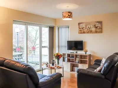 a living room with two leather couches and a tv at Arenig - Uk48508 in Bala