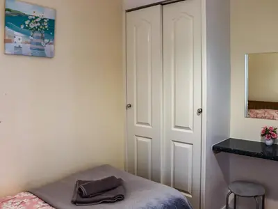 a bedroom with a bed and a mirror and a door at Arenig - Uk48508 in Bala