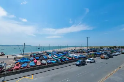 a bunch of boats parked next to the beach at Fabulous Sea View Apartment in Aberdyfi
