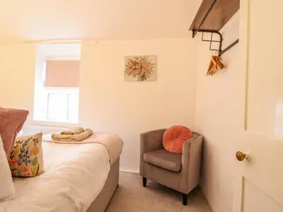 a living room with a chair and a couch at Golygfa'r Orsaf Snowdonia National Park in Bala