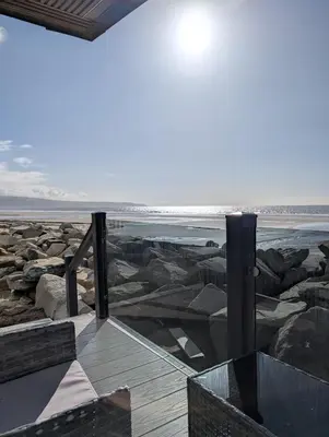a view of the beach from a house at Lyons Sunnysands Caravan Park in Barmouth