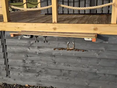 a wooden deck with a rope and a pair of handcuffs at Ty'r Bugail - Shepherds Hut in Llanddwywe