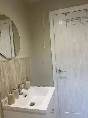a white bathroom with a sink and a mirror at Dog & Family Friendly Private Cottage in Orleton in Orleton