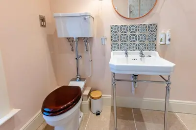 a bathroom with a toilet and a sink at The Garden Cottage in Craven Arms
