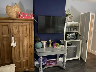 a living room with a tv and a table at Sy3 Shrewsbury in Shrewsbury