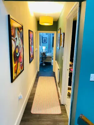 a hallway with a painting on the wall and a carpet at Sy3 Shrewsbury in Shrewsbury