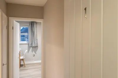 a hallway with a door leading into a room at Modern Town Centre Apartment in Leominster