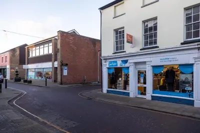 an empty street in a town with buildings at Modern Town Centre Apartment in Leominster