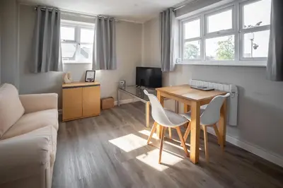 a small living room with a table and chairs at Modern Town Centre Apartment in Leominster