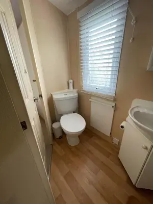 a small bathroom with a toilet and a sink at The Perfect Escape 2 Bedroom Static Caravan Pet Friendly in Aberystwyth