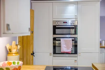 a kitchen with white cabinets and an oven at 2 Bed in Woofferton oc-b29941 in Woofferton