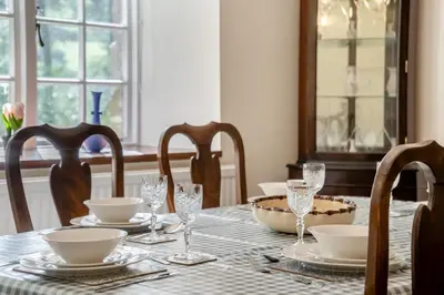 a dining room table with plates and glasses on it at 3 Bed in Scethrog oc-h30013 in Scethrog